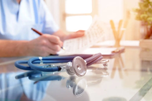 Doctor reviewing paperwork with stethoscope